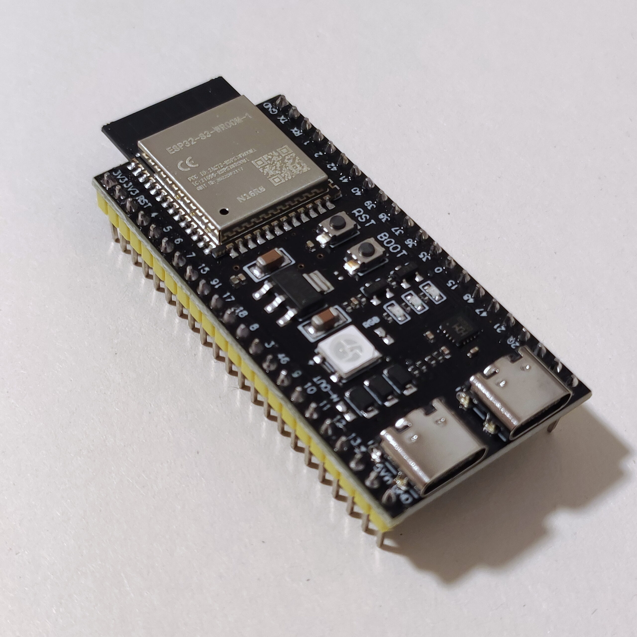 An ESP32-S3 development board on paper, used as an illustrative hardware photograph; not the XIAO board from the firmware release.