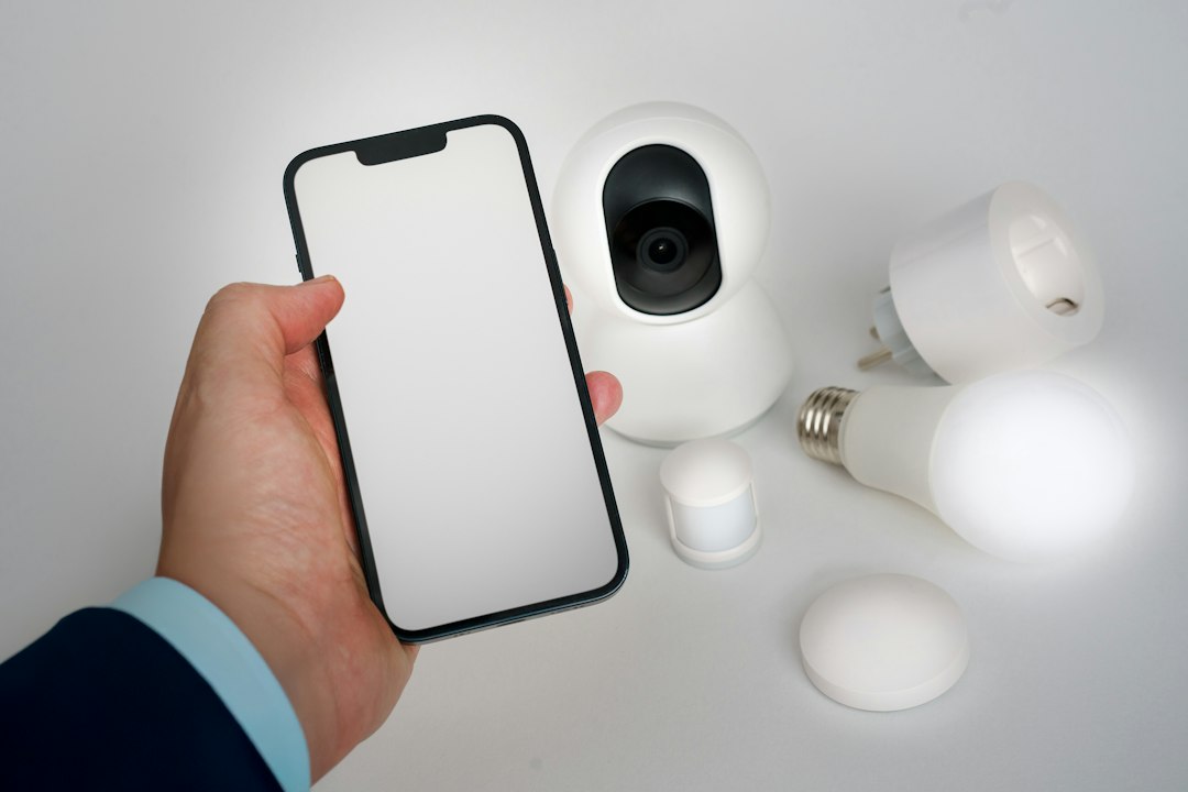 Smartphone beside a smart-home camera, used as an illustrative image